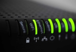 Close up view of a wifi router with green lights
