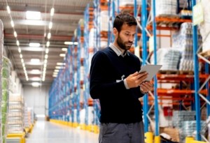 Warehouse manager using a tablet for inventory management